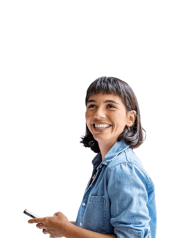 Woman in blue shirt holding phone and smiling at the camera