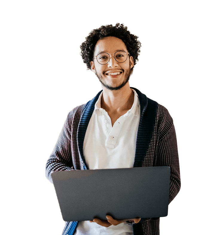Smiling man with curly hair and glasses holding an open laptop in front of him, wearing a white shirt and dark cardigan against a black background.