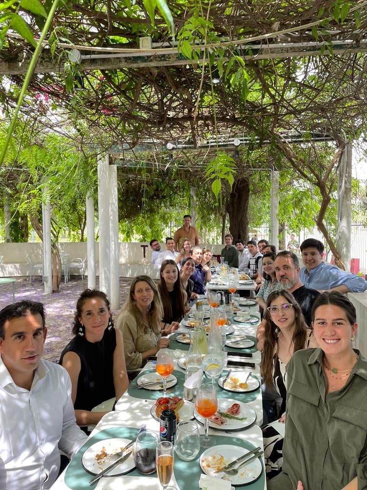 Group of people having dinner under tree canopy