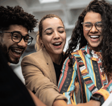 a cheerful group of diverse colleagues huddled together emphasizing a collaborative workplace