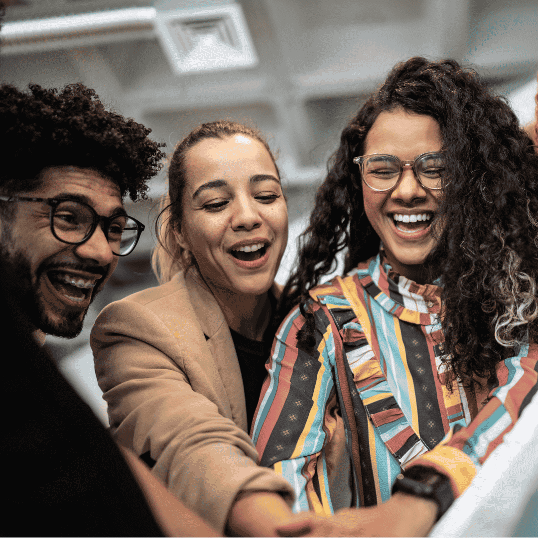 a cheerful group of diverse colleagues huddled together emphasizing a collaborative workplace