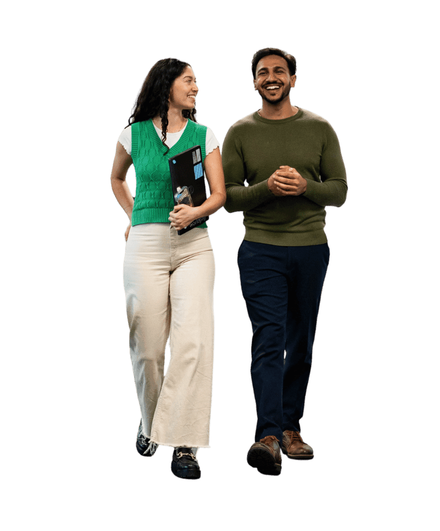 two people walking wearing green sweaters