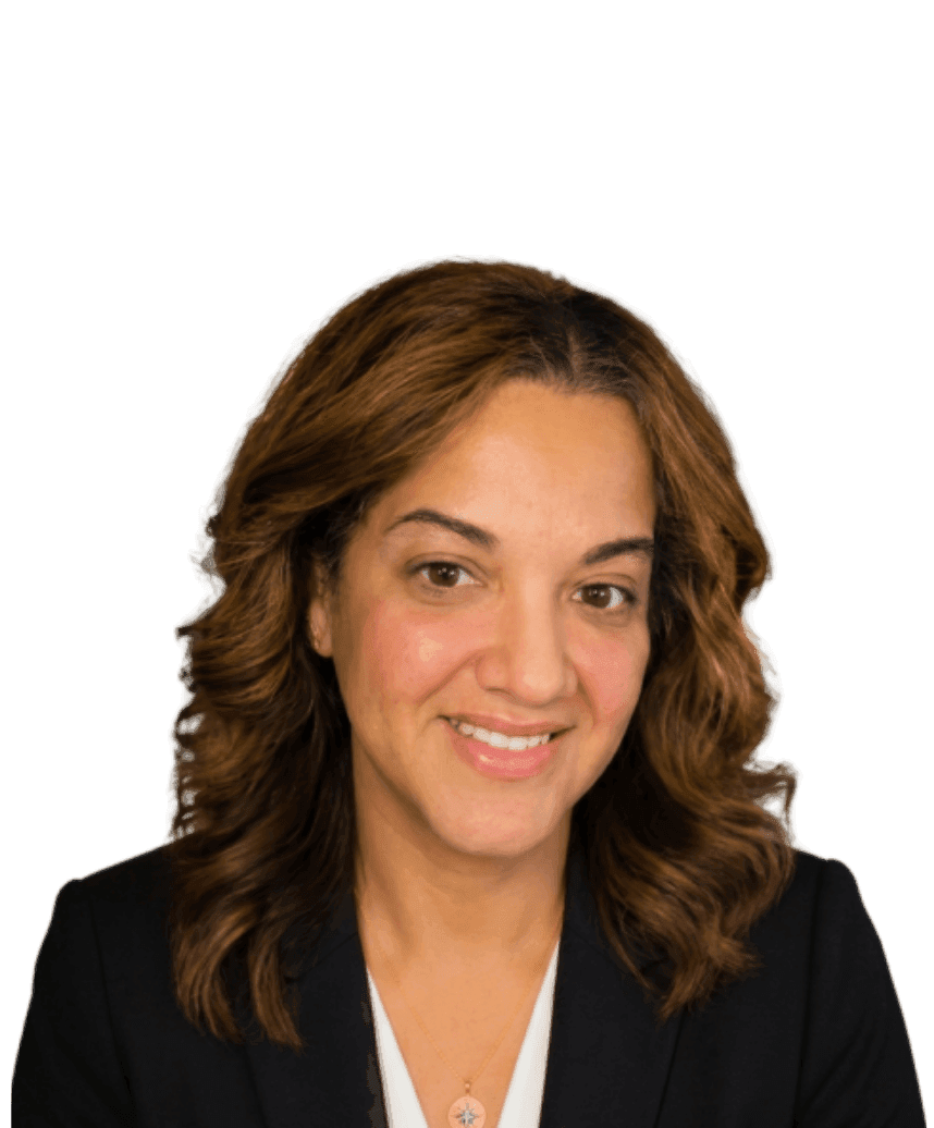 Portrait of a smiling person with shoulder-length wavy brown hair wearing a black blazer over a white top, facing the camera.